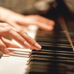 Beautiful Piano Melody...Close up view of female hands playing on piano her favorite classical music